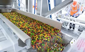Mars uses artificial to sort Skittles colors, ensuring an array of colors in each pack. Photograph shows Skittles coming down the production line. 