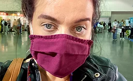 Crystal Lindell wearing a maroon face mask. 