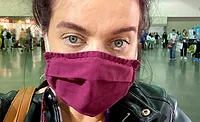 Crystal Lindell wearing a maroon face mask. 