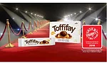 Toffifay delivers a highly unique eating experience with its whole roasted hazelnut, chewy caramel cup, hazelnut cream and drop of chocolate.