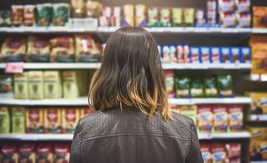 grocery store shelves and woman